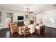Living room with hardwood floors, wicker chairs, and a view of the backyard at 5701 S Macdill Ave, Tampa, FL 33611