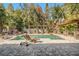 Resort-style backyard oasis with a pool, pergola, and fireplace at 5701 S Macdill Ave, Tampa, FL 33611