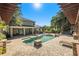 Luxury backyard with a sparkling pool and pergola covered patio at 5701 S Macdill Ave, Tampa, FL 33611