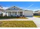 Craftsman style home with gray siding, a covered porch, and a two-car garage at 5917 Hidden Branch Dr, Apollo Beach, FL 33572