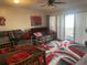 Living room with gray couches, red accents, and a dining table at 7701 Starkey Rd # 306, Seminole, FL 33777