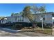 Gray manufactured home with tree and landscaped yard at 8512 Fantasia Park Way, Riverview, FL 33578