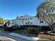 Single-wide manufactured home with landscaped yard and covered entry at 8512 Fantasia Park Way, Riverview, FL 33578