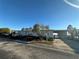 Gray manufactured home with carport and lake view at 8512 Fantasia Park Way, Riverview, FL 33578