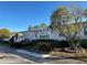 Gray manufactured home with tree and landscaped yard at 8512 Fantasia Park Way, Riverview, FL 33578