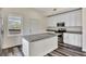 Modern kitchen with white cabinets and granite island at 912 E 20Th Ave, Tampa, FL 33605