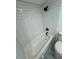 Clean bathroom with white subway tile and grey floor at 915 E 20Th Ave, Tampa, FL 33605
