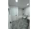 Updated bathroom, featuring subway tile and grey floor at 915 E 20Th Ave, Tampa, FL 33605