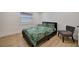 Cozy bedroom featuring a double bed and a chair at 915 E 20Th Ave, Tampa, FL 33605