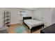 Cozy bedroom with a black bed frame and teal rug at 915 E 20Th Ave, Tampa, FL 33605