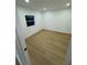 Well-lit bedroom, featuring wood-look floors and white walls at 915 E 20Th Ave, Tampa, FL 33605