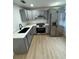 Modern kitchen with gray cabinets and stainless steel appliances at 915 E 20Th Ave, Tampa, FL 33605