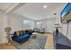 Bright living room with comfy blue couch and decorative rug at 915 E 20Th Ave, Tampa, FL 33605