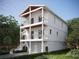 Two-story home with white siding, balcony, and attached garage at 96 Shore Dr, Tarpon Springs, FL 34689