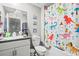 Bathroom with tub and dinosaur-themed shower curtain at 9642 Pembrooke Pines Dr, Sun City Center, FL 33573