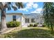 Landscaped backyard with a screened patio and lush greenery at 10038 Reagan Dairy Trl, Bradenton, FL 34212