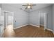 Bedroom with wood floors, ceiling fan and en-suite bathroom at 10038 Reagan Dairy Trl, Bradenton, FL 34212