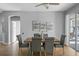 Dining area with a wooden table, gray chairs, and access to a patio at 10038 Reagan Dairy Trl, Bradenton, FL 34212