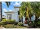 Front entrance with a screened door and tropical landscaping at 10038 Reagan Dairy Trl, Bradenton, FL 34212