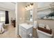 Bathroom with white vanity, toilet, and beach-themed wall art at 10764 70Th Ave # 1303, Seminole, FL 33772