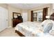 Bedroom with dresser, TV, and bed with light blue and beige comforter at 10764 70Th Ave # 1303, Seminole, FL 33772