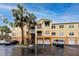 Condo building exterior with palm trees and parking at 10764 70Th Ave # 1303, Seminole, FL 33772