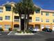 Condo building exterior with palm trees and parking at 10764 70Th Ave # 1303, Seminole, FL 33772