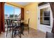 Private lanai with table and chairs, offering outdoor dining space at 10764 70Th Ave # 1303, Seminole, FL 33772