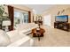 Bright living room with comfy sofas, coffee table, and large TV at 10764 70Th Ave # 1303, Seminole, FL 33772