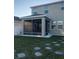 Backyard with screened patio and stone pathway at 10913 Kidron Valley Ln, Tampa, FL 33625