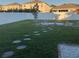 Spacious backyard with stone pathway and lawn at 10913 Kidron Valley Ln, Tampa, FL 33625