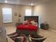 Bright bedroom with red bedding and two nightstands at 10913 Kidron Valley Ln, Tampa, FL 33625