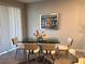 Elegant dining room with glass table, chrome chairs, and modern art at 10913 Kidron Valley Ln, Tampa, FL 33625