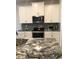 Modern kitchen with white cabinets, granite countertops, and stainless steel appliances at 10913 Kidron Valley Ln, Tampa, FL 33625