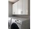 Laundry room with white cabinets and Samsung washer/dryer at 10913 Kidron Valley Ln, Tampa, FL 33625