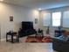 Spacious living room with large TV, comfortable seating, and tiled floors at 10913 Kidron Valley Ln, Tampa, FL 33625