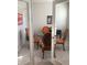 Home office with glass french doors, wood table, and orange chairs at 10913 Kidron Valley Ln, Tampa, FL 33625