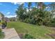 Spacious backyard with lush landscaping and grassy area at 1157 Eden Isle Ne Blvd # 3, St Petersburg, FL 33704