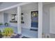 Front entry with a blue door, porch, and potted plants at 1331 Brunswick Dr, Clearwater, FL 33756