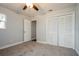 Bright bedroom with grey carpet, ceiling fan, and spacious closet at 13901 Bardmoor Pl # A, Tampa, FL 33618