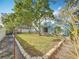 Expansive backyard with a grassy area and mature trees at 14721 Condor Pass, Clearwater, FL 33760