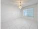 Simple dining room with tiled floors and a window with blinds at 14721 Condor Pass, Clearwater, FL 33760
