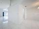 Bright and airy hallway with tiled floors and neutral walls at 14721 Condor Pass, Clearwater, FL 33760