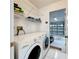 Laundry room with washer, dryer, and access to garage at 14721 Condor Pass, Clearwater, FL 33760