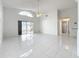 Living room with tile floor, sliding glass doors, and vaulted ceiling at 14721 Condor Pass, Clearwater, FL 33760