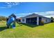Large backyard with playset and view of house at 17721 Bright Wheat Dr, Lithia, FL 33547
