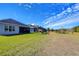 Grass backyard with playset and view of a pond at 17721 Bright Wheat Dr, Lithia, FL 33547