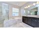 Elegant bathroom with marble flooring, soaking tub, and glass shower at 17721 Bright Wheat Dr, Lithia, FL 33547