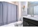 Clean bathroom with dark vanity and gray shower curtain at 17721 Bright Wheat Dr, Lithia, FL 33547