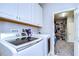 Laundry room with washer, dryer, and access to additional storage at 17721 Bright Wheat Dr, Lithia, FL 33547